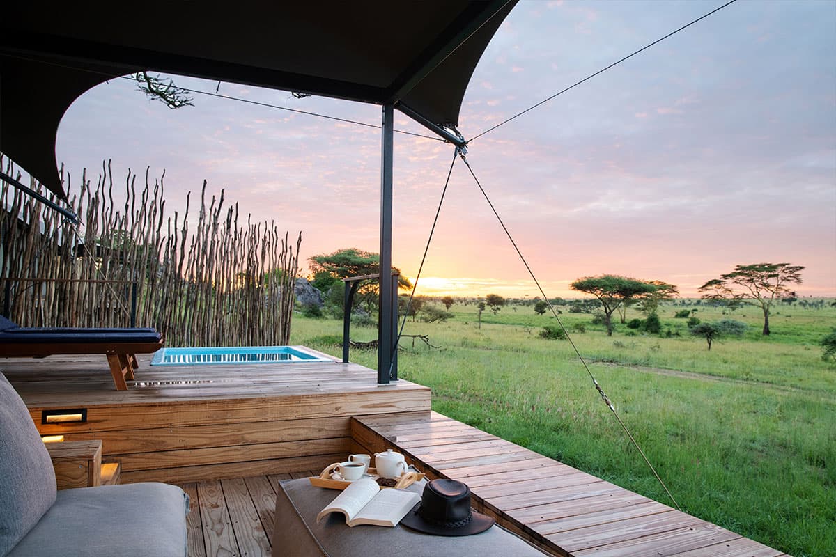 Private tented camp deck with plunge pool and dawn savanna view
