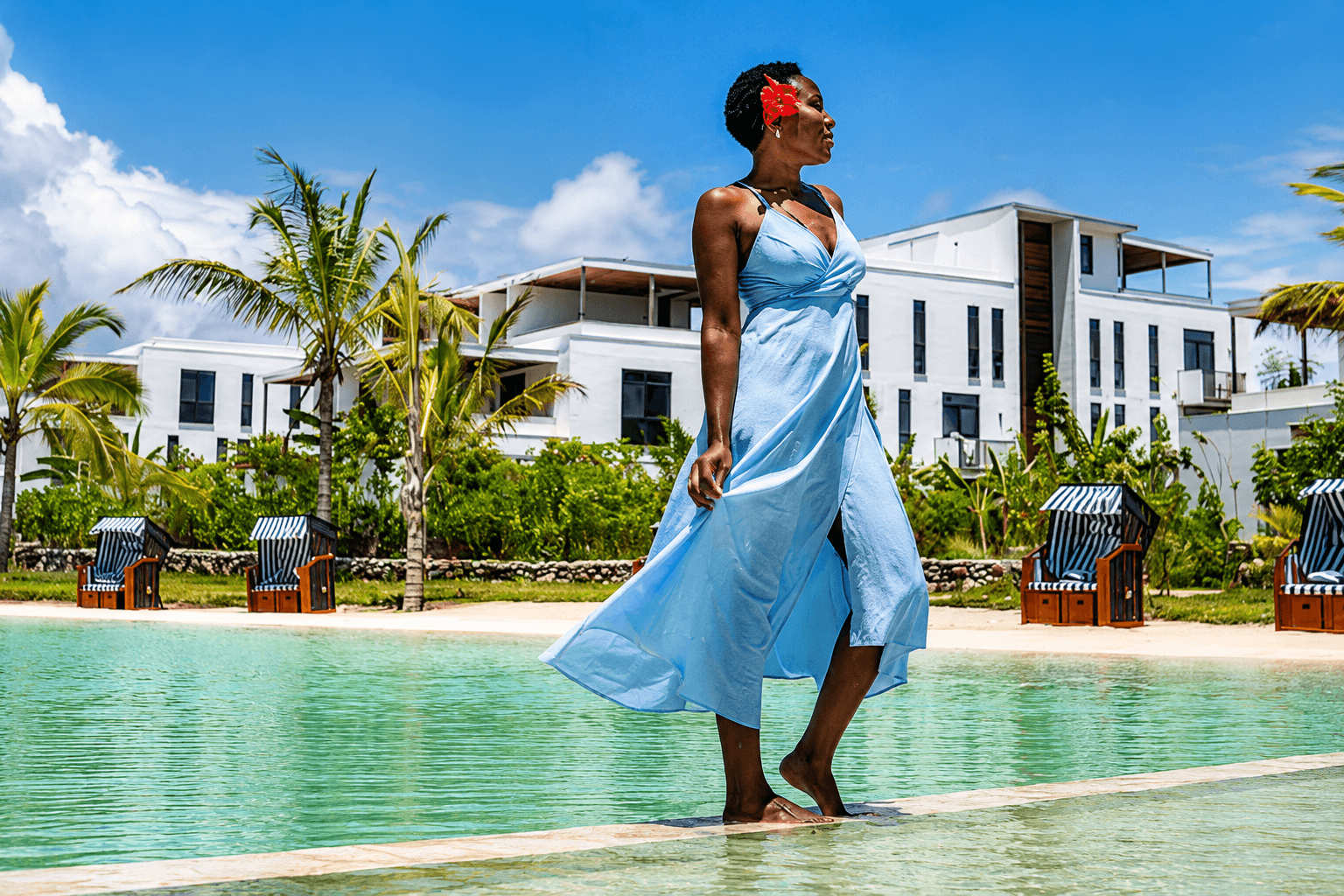 A guest enjoying the lagoon pool at P.O.M.-P.O.M. Suites Paje, Zanzibar